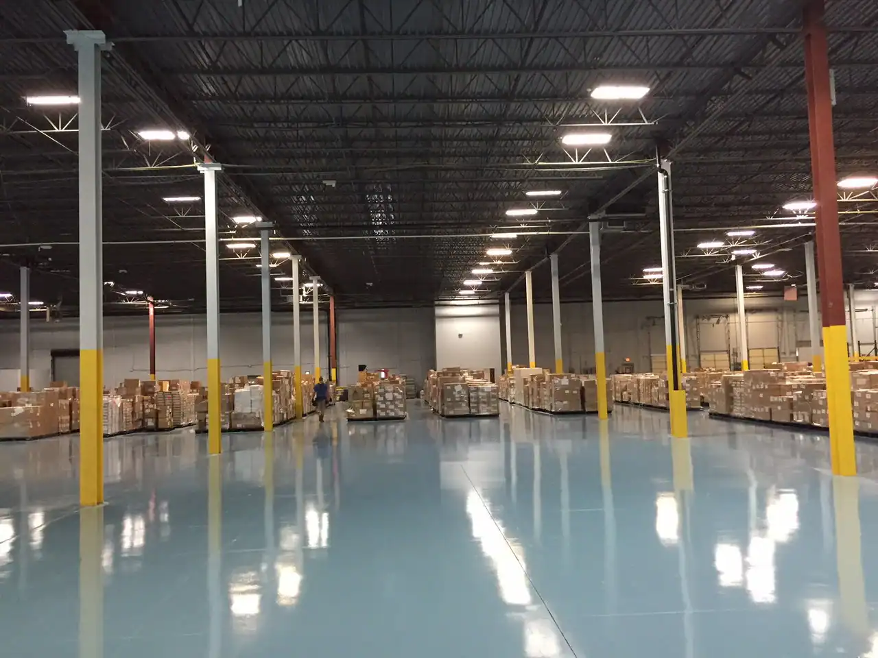Spacious New York warehouse with epoxy floors, high ceilings, and pallets lined up along the back wall.