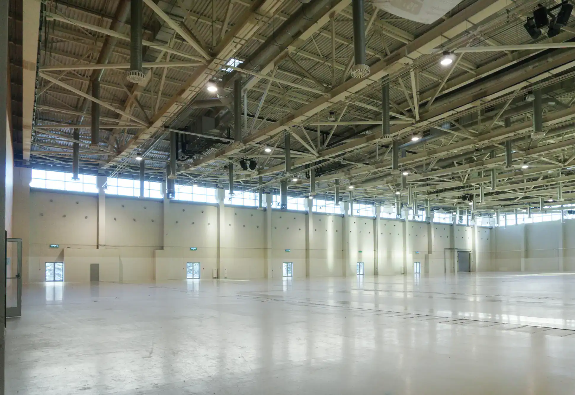 Spacious NY warehouse with high ceilings, exposed beams, and rows of windows&mdash;ideal for epoxy flooring.